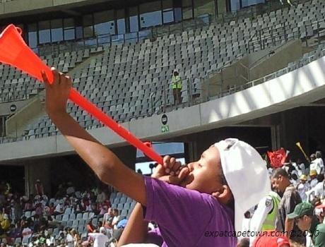 Child blowing a vuvuzela